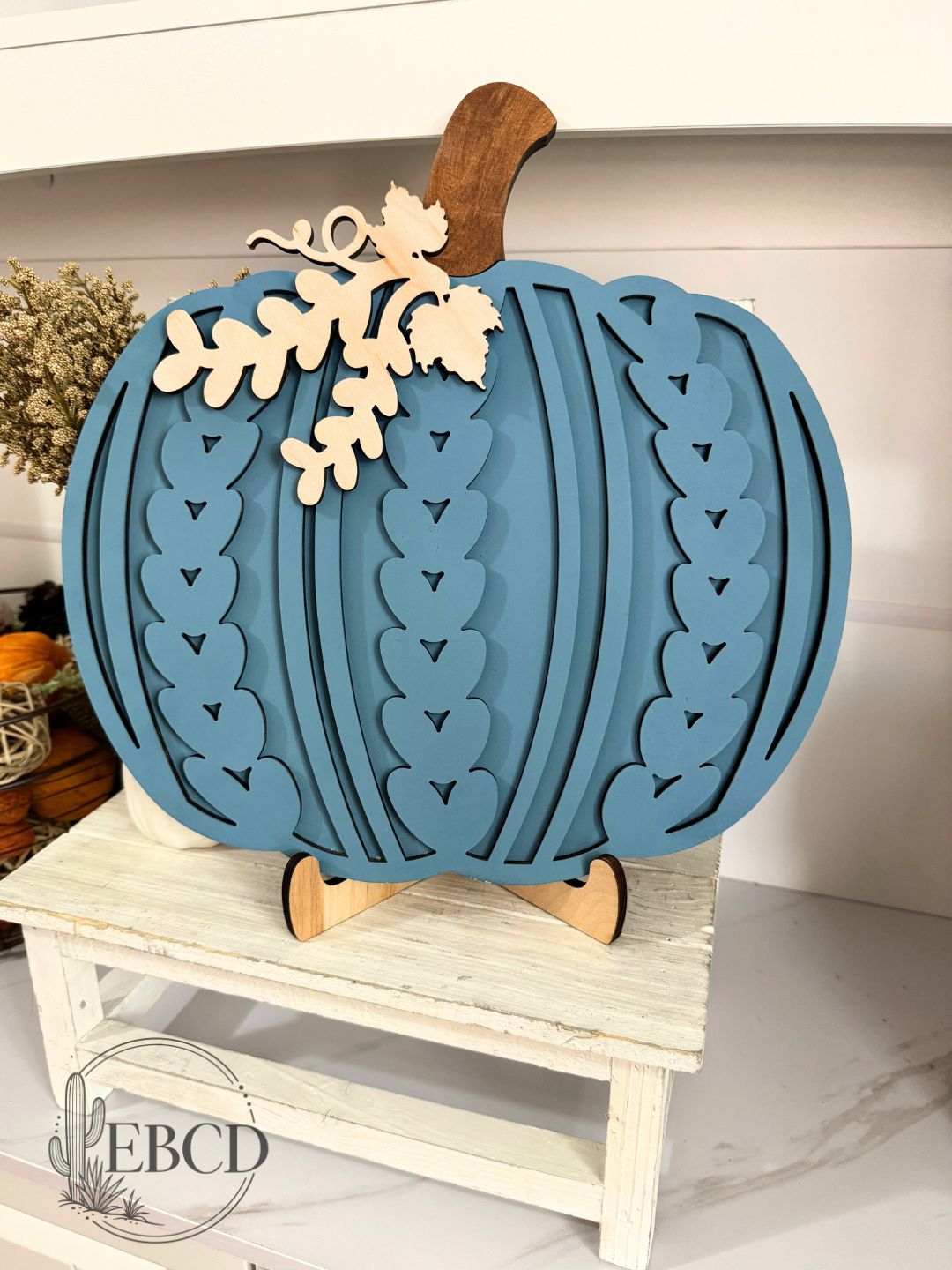 Hand painted Sweater Pumpkin fall decor with layered wood details, natural wood stem and leaf accents.
