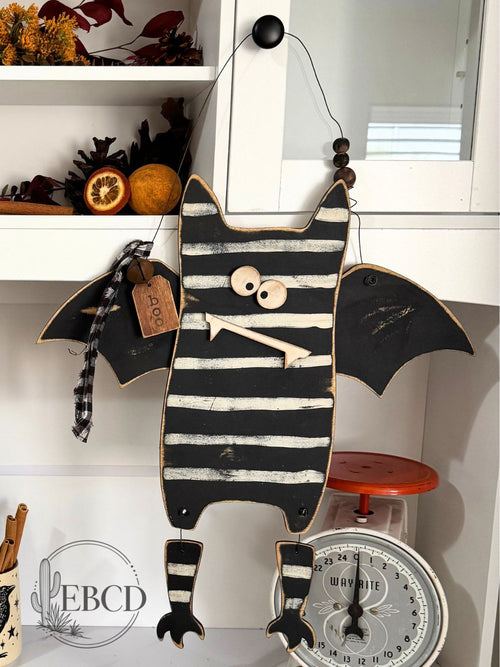Hand painted Halloween bat decor with dangling legs, wood beads, fabric accents and BOO tag.