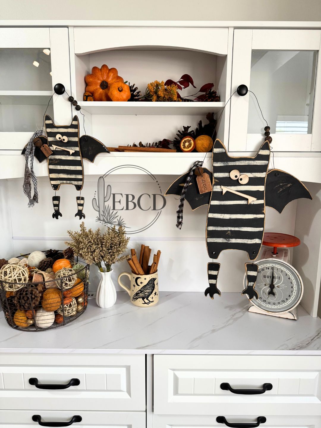 Hand painted Halloween bat decor with dangling legs, wood beads, fabric accents and BOO tag.