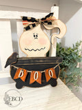 Boo in the Brew hand painted Halloween ghost decor with black cauldron, crow and orange BOO banner.